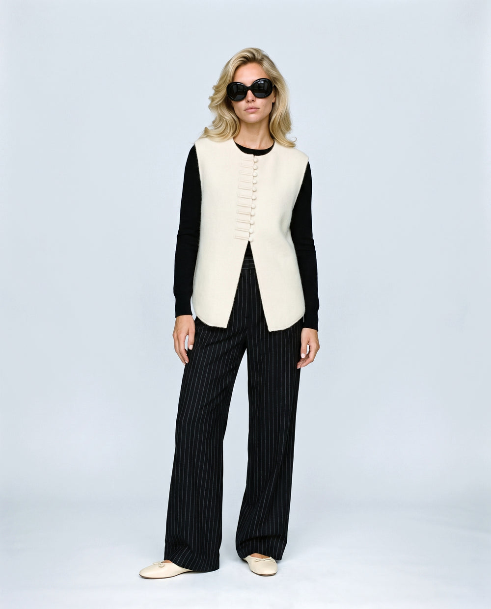 The Knot-Button Knit Vest in Cream, front view on a non-pregnant model