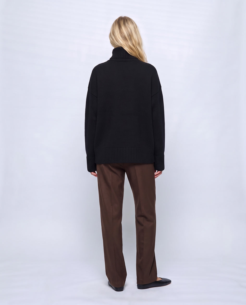 Louise Relaxed Roll-Neck Sweater in Black, back view on a non-pregnant model