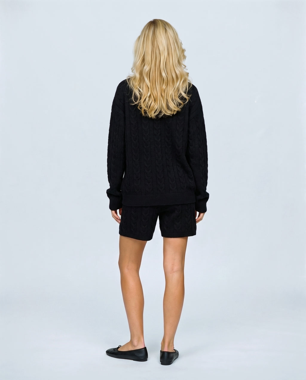 The Cable Knit Shorts Set in Black, back view on a non-pregnant model