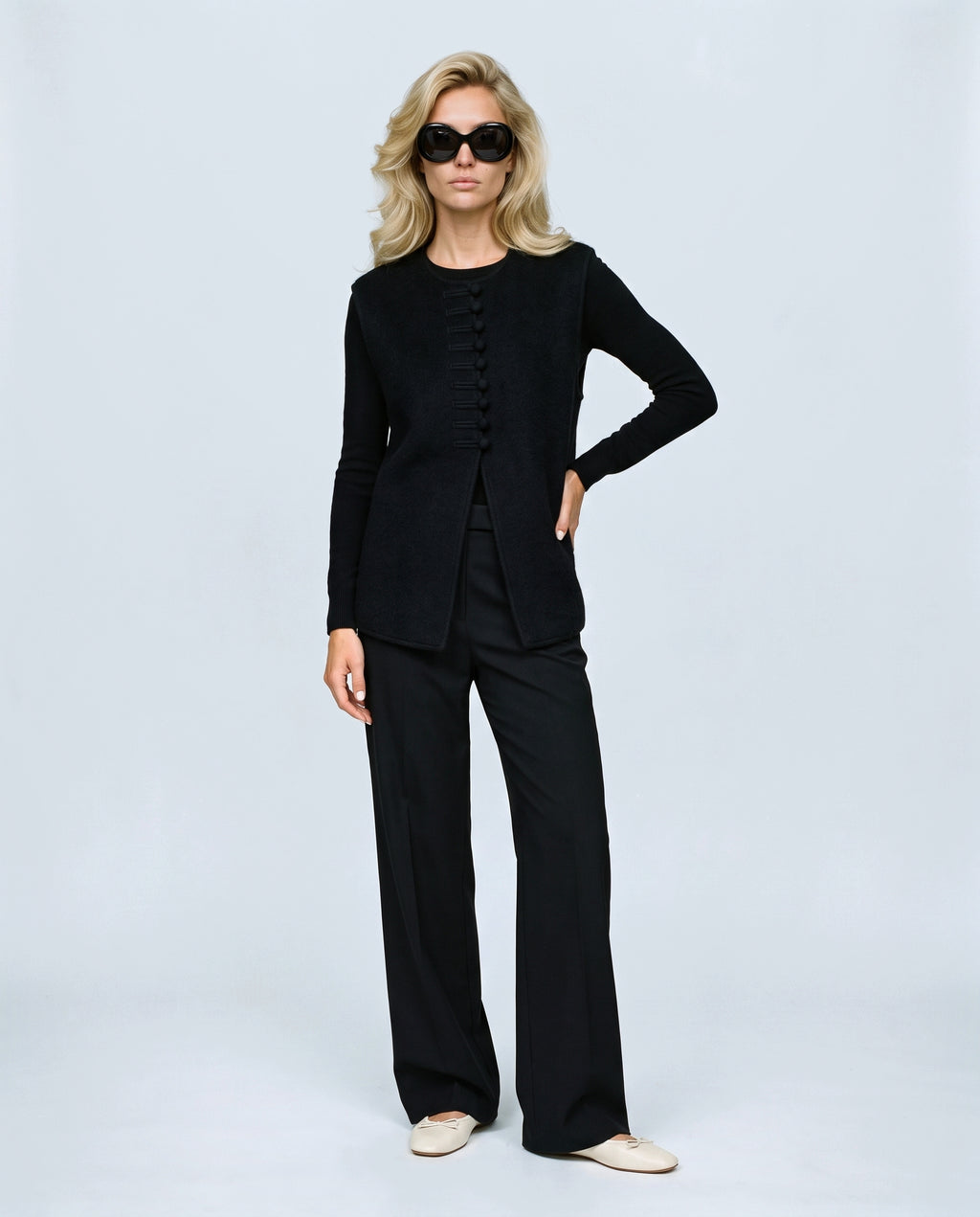 The Knot-Button Knit Vest in Black, front view on a non-pregnant model
