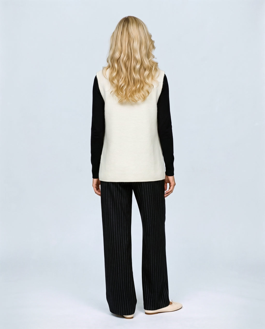 The Knot-Button Knit Vest in Black, back view on a non-pregnant model