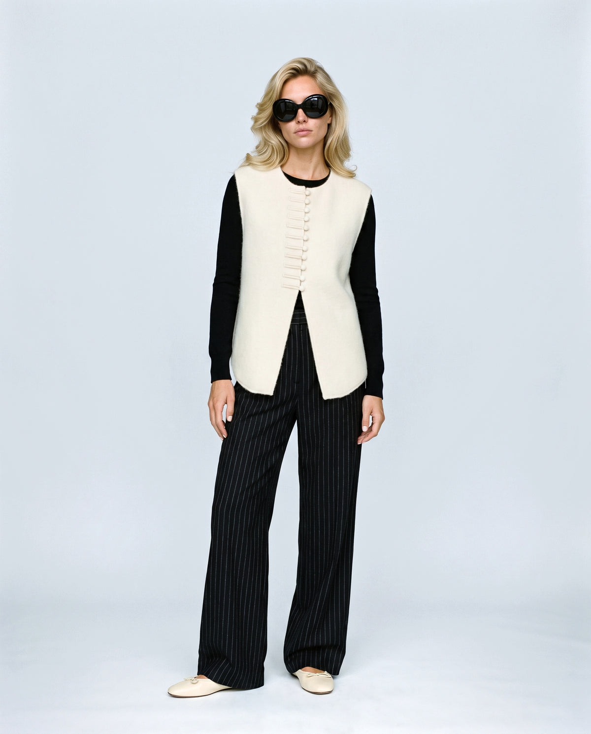 The Knot-Button Knit Vest in Cream, front view on a non-pregnant model