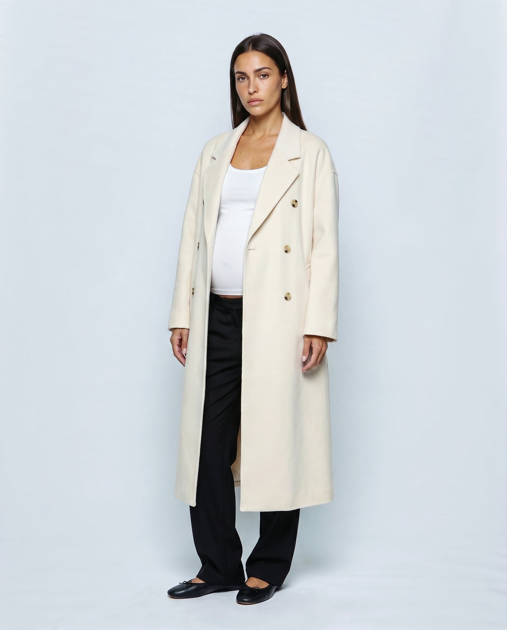 The Cocoon Overcoat in Cream, closed over the bump