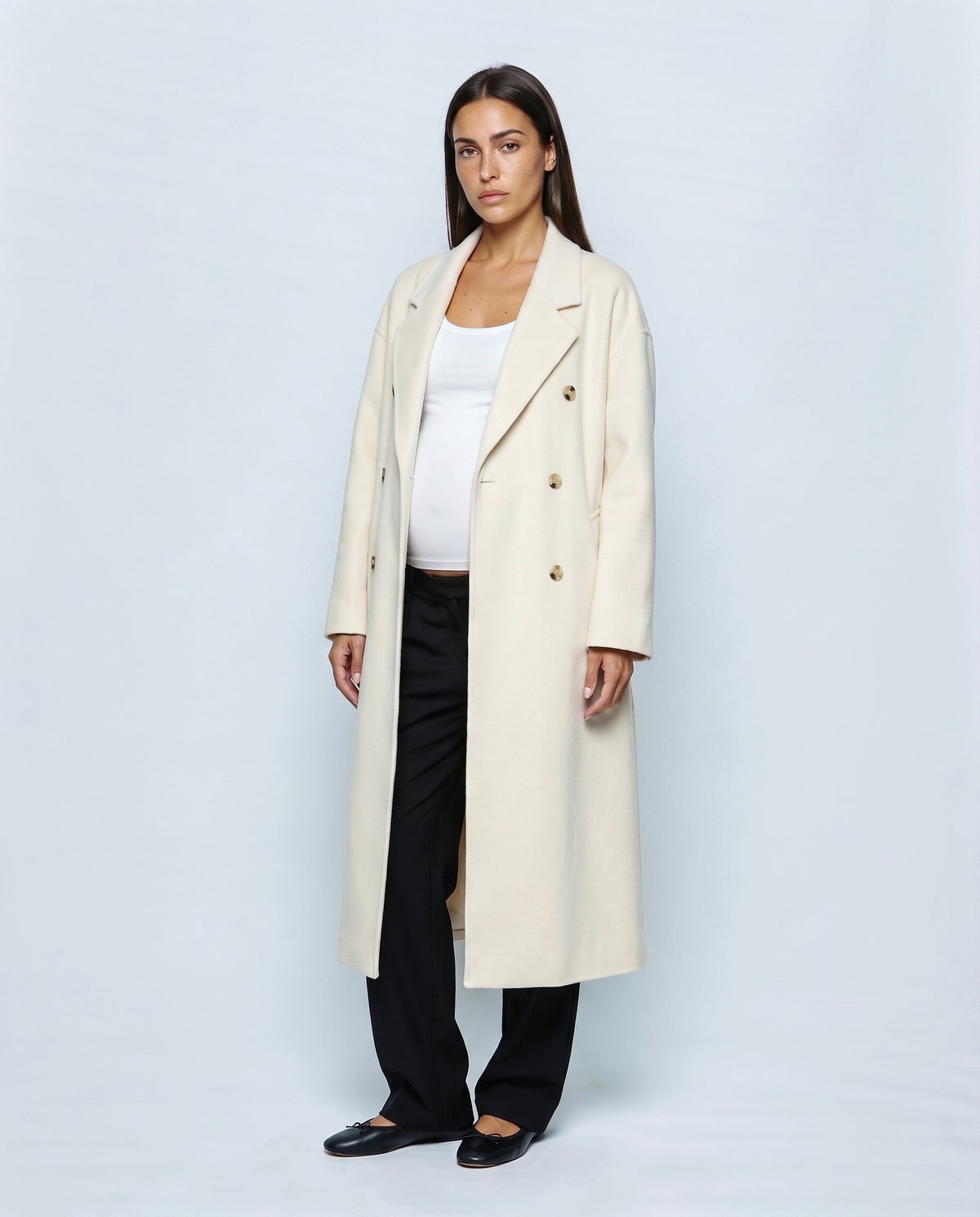 The Cocoon Overcoat in Cream, closed over the bump