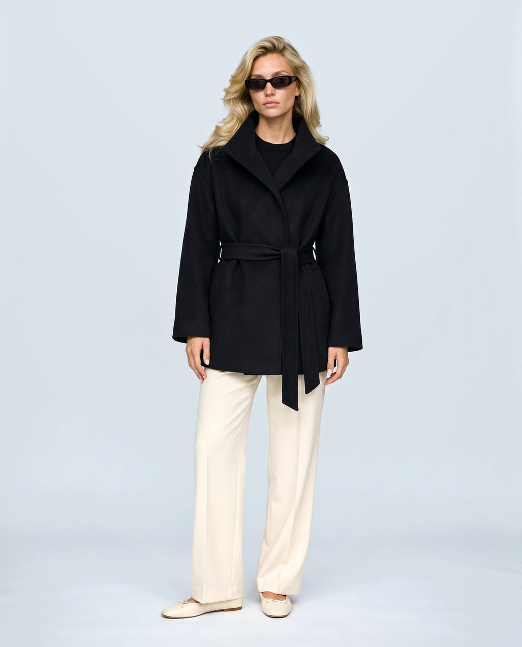 The Belted Stand-Collar Coat in Black, front view on a non-pregnant model