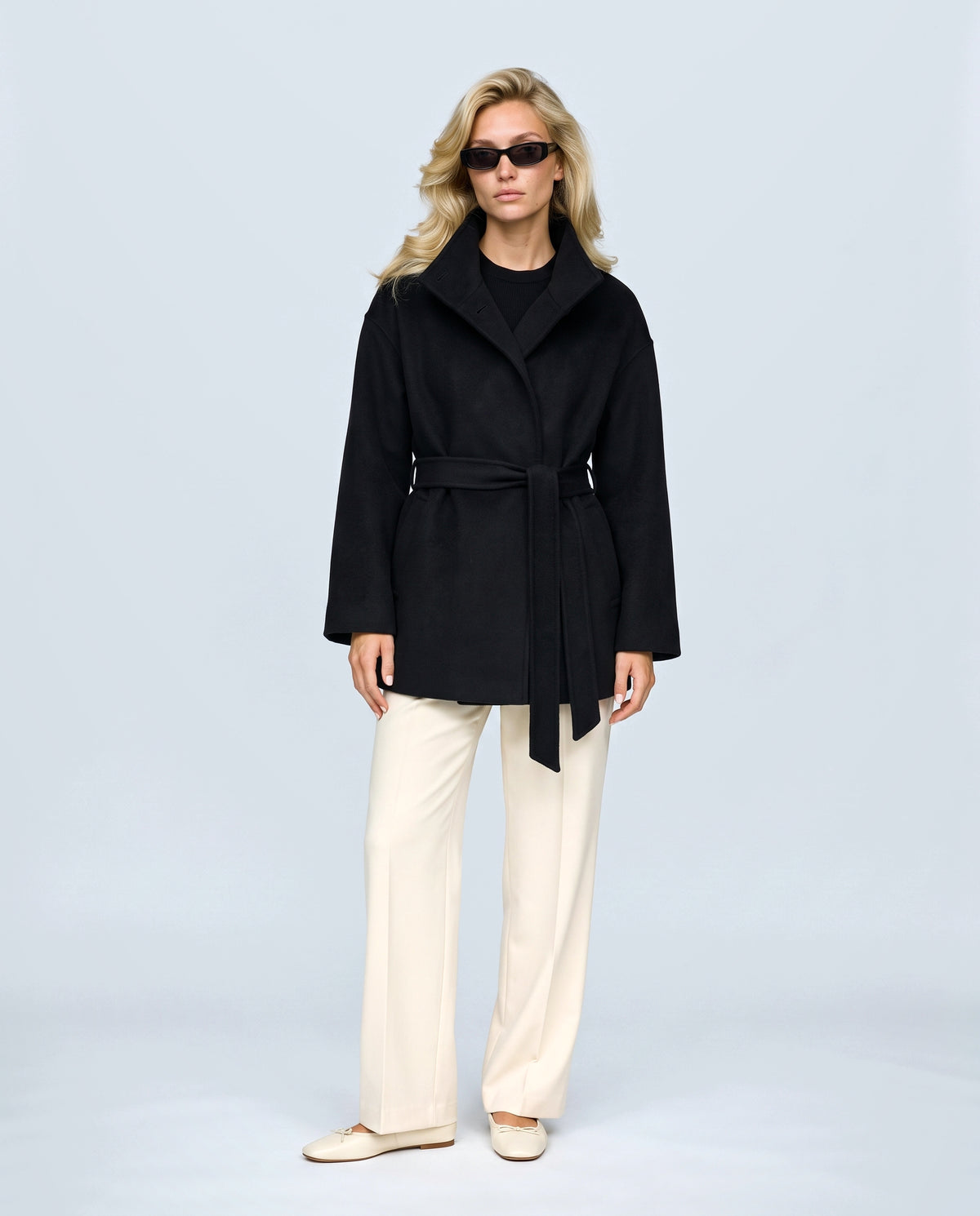 The Belted Stand-Collar Coat in Black, front view on a non-pregnant model
