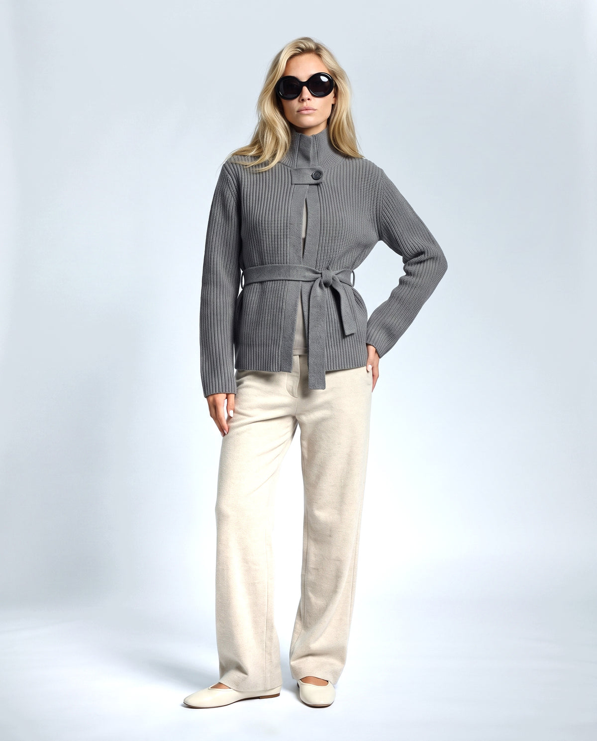 The Belted High-Neck Cardigan in Grey, front view on a non-pregnant model