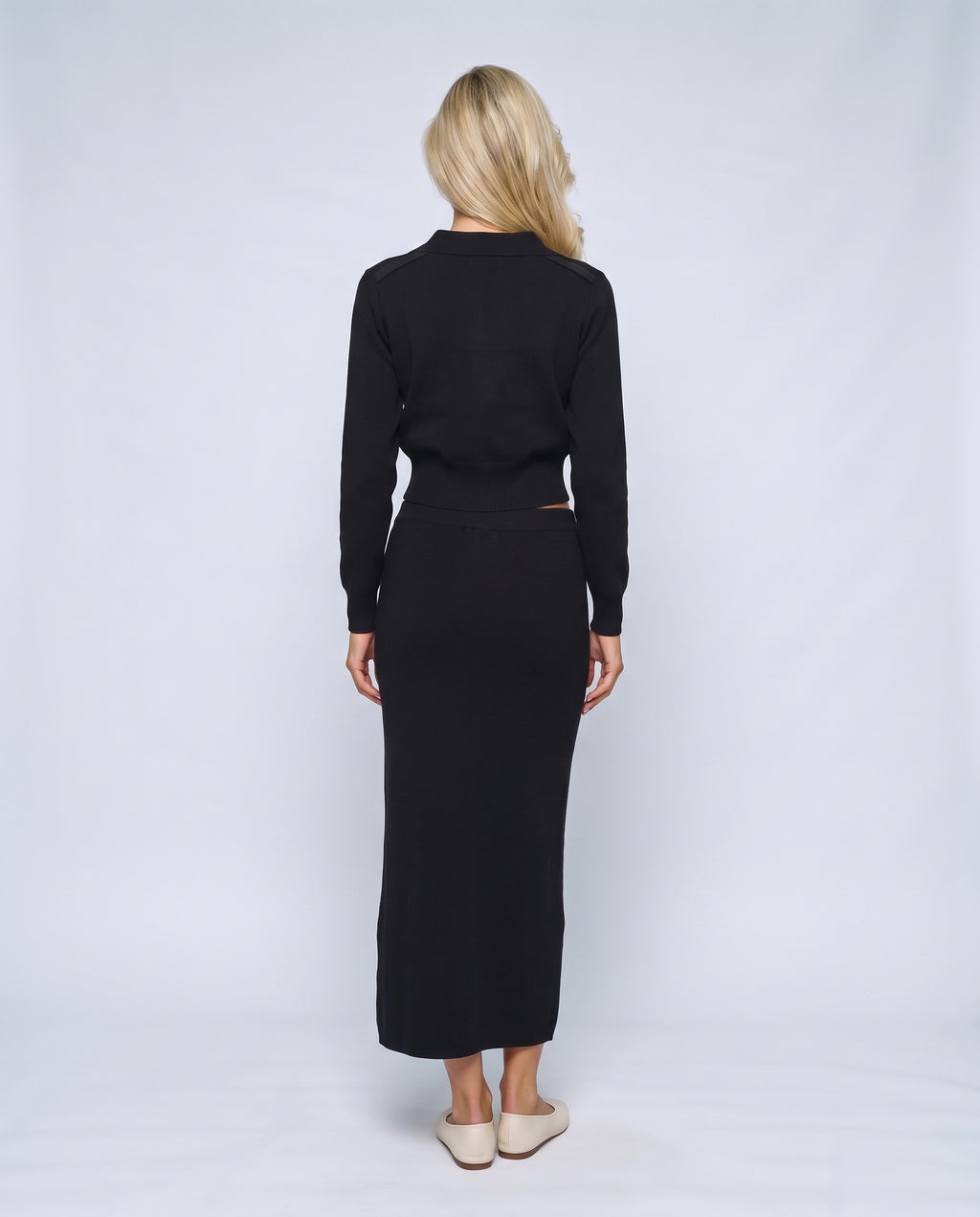 The Knit Blazer & Skirt Set in Black, back view on a non-pregnant model