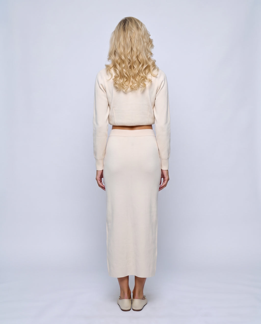 The Knit Blazer & Skirt Set in White, back view on a non-pregnant model