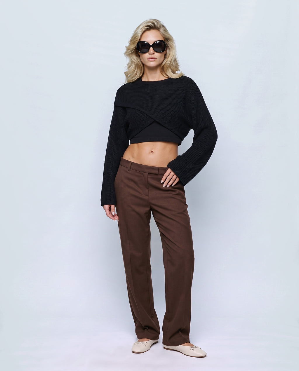 The Crossover Cropped Knit in Black, front view on a non-pregnant model