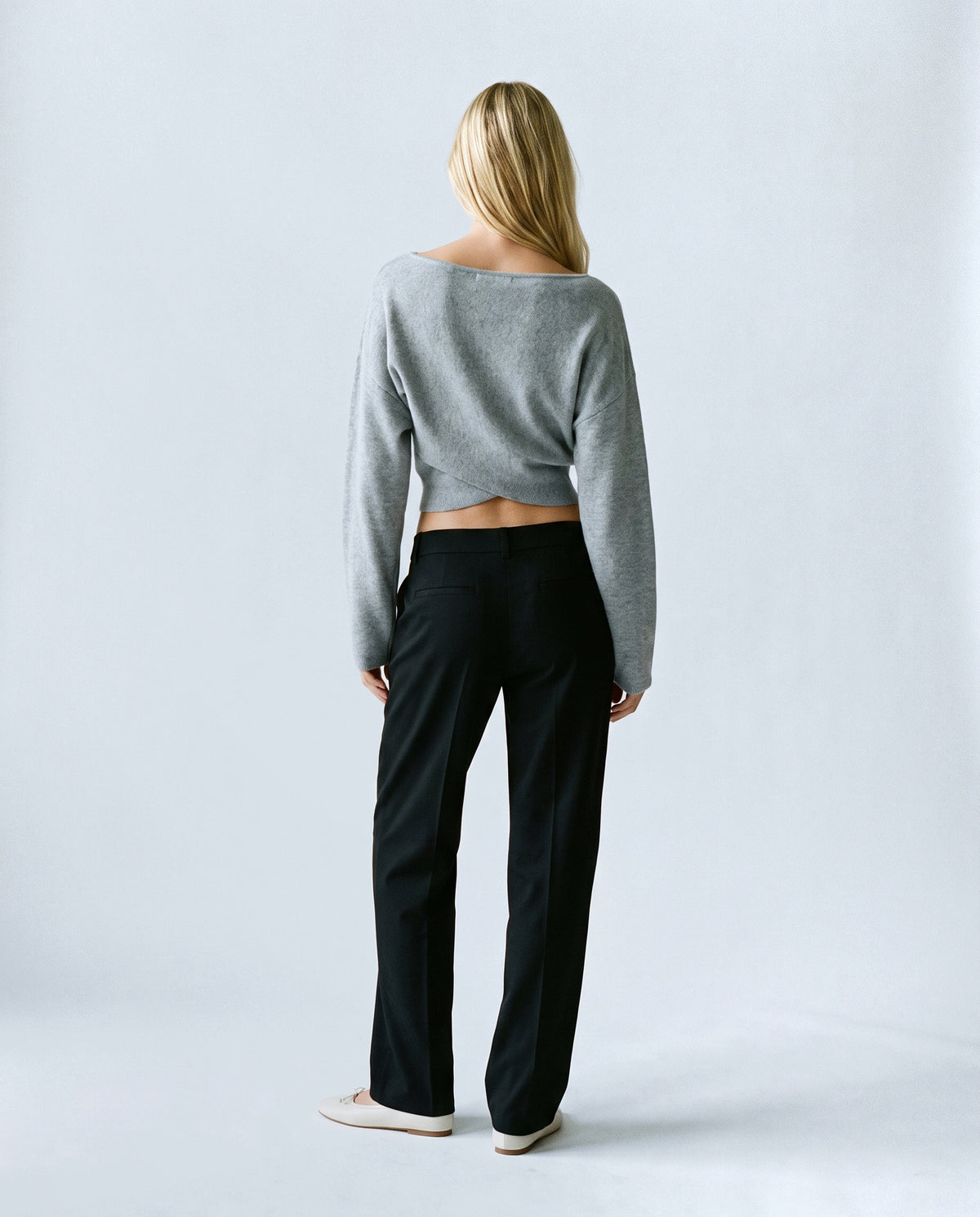 The Crossover Cropped Knit in Grey, back view on a non-pregnant model