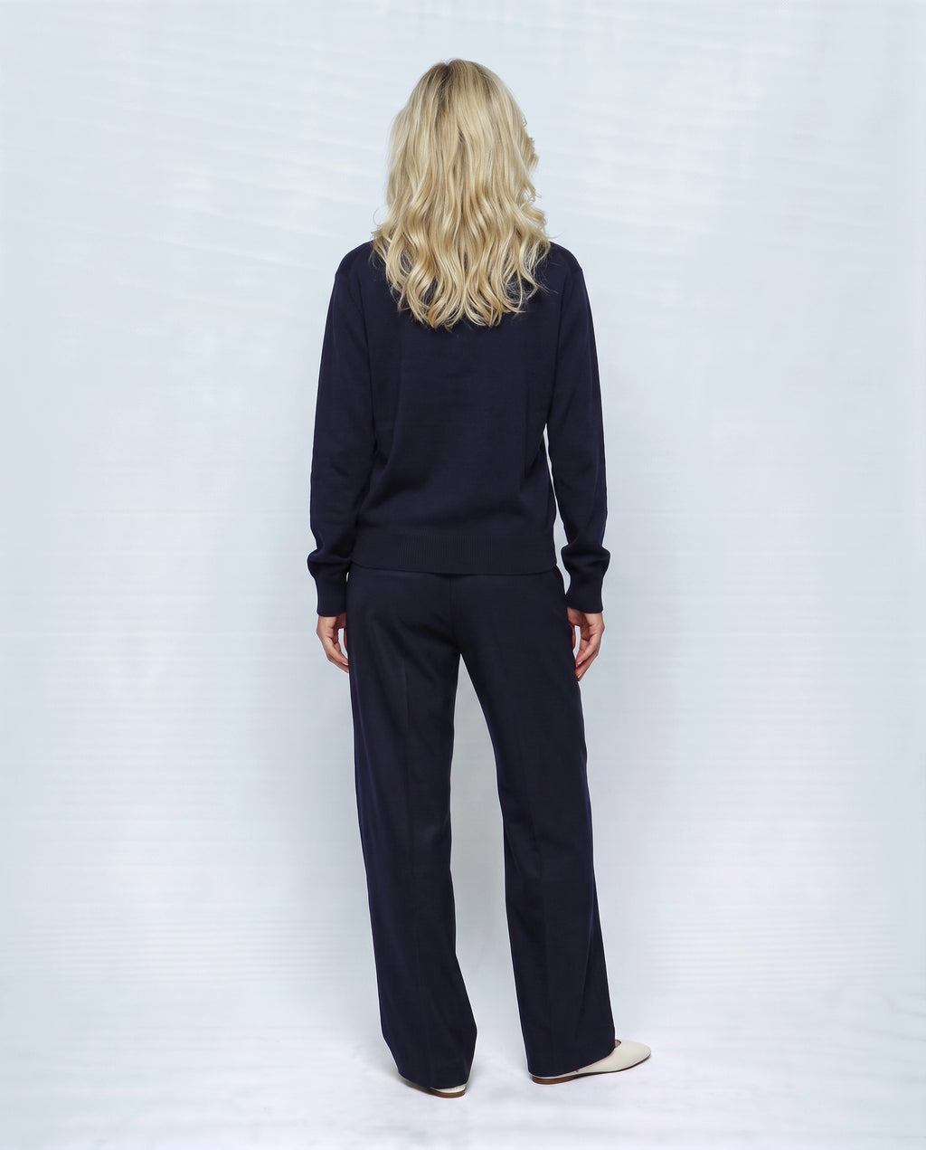The Stand-Collar Cardigan in Navy, back view on a non-pregnant model