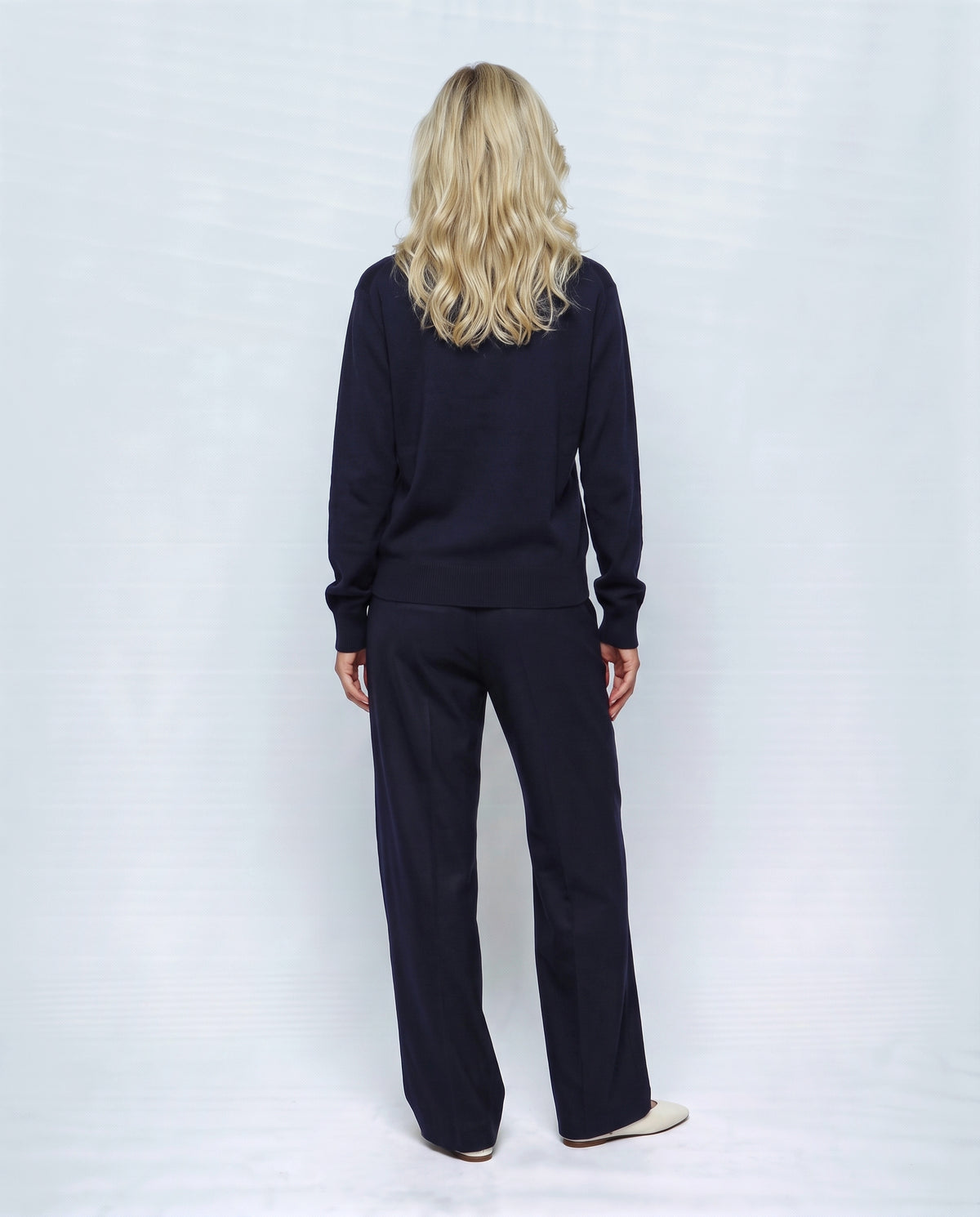The Stand-Collar Cardigan in Navy, back view on a non-pregnant model