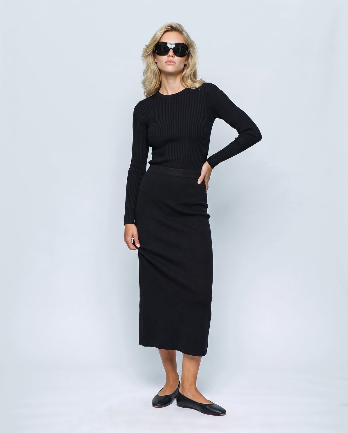 The Column Knit Skirt in Black, front view on a non-pregnant model