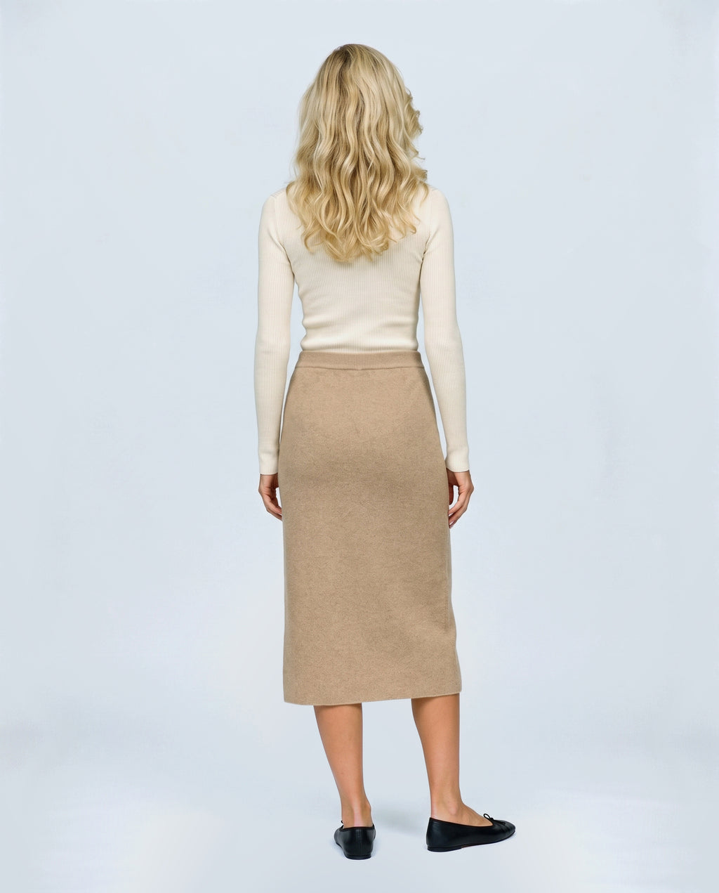 The Column Knit Skirt in Camel, back view on a non-pregnant model