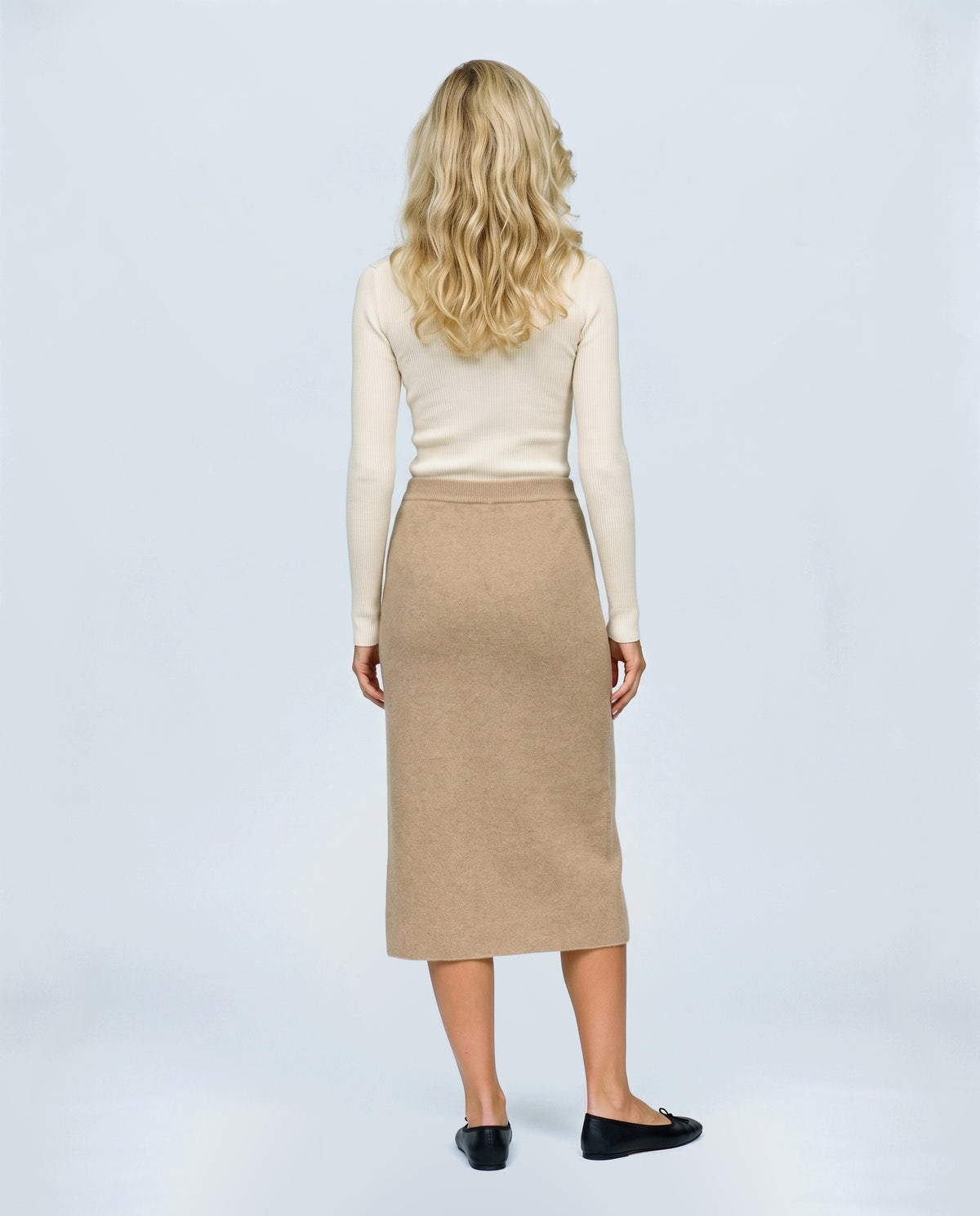 The Column Knit Skirt in Camel, back view on a non-pregnant model