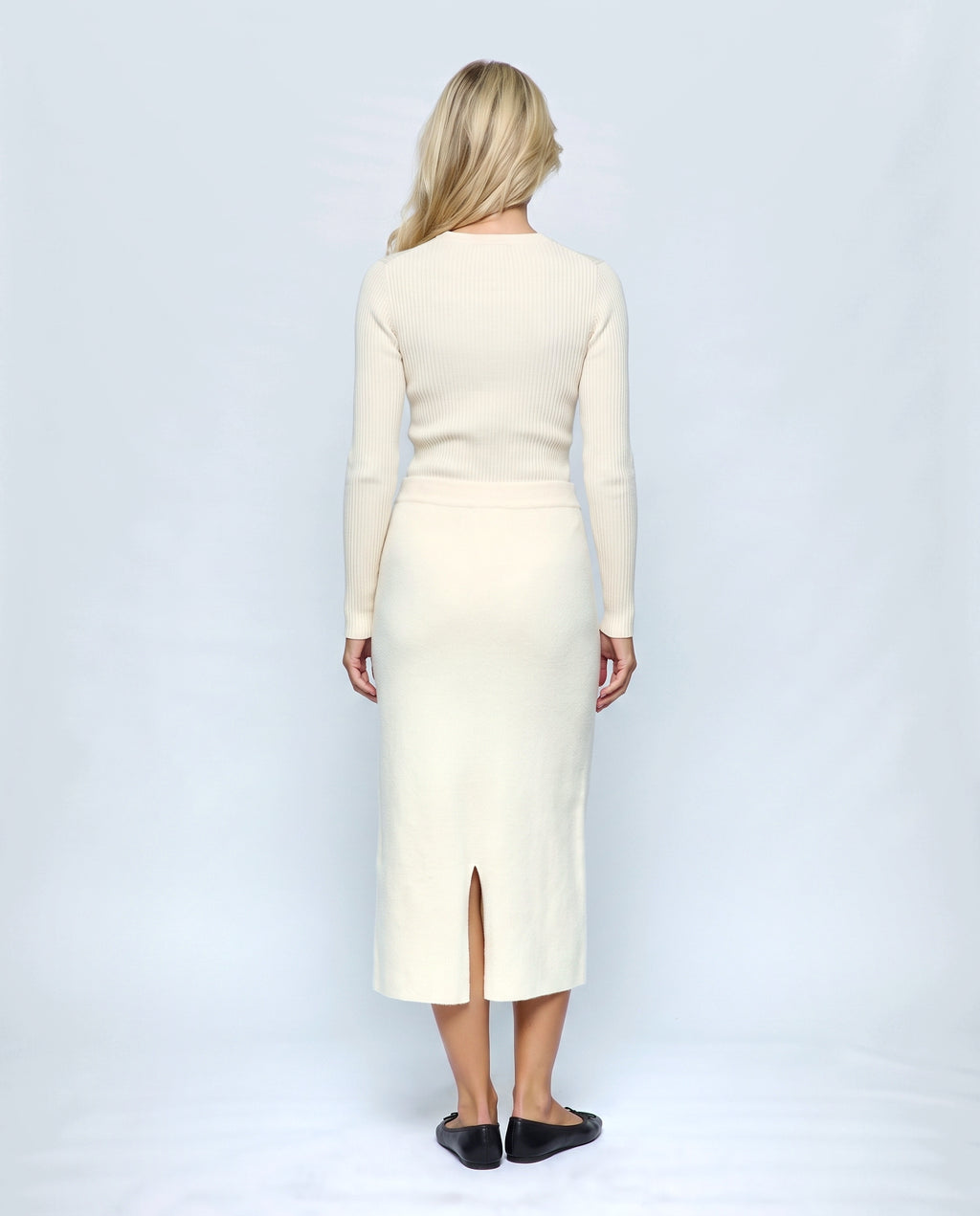 The Column Knit Skirt in Cream, back view on a non-pregnant model