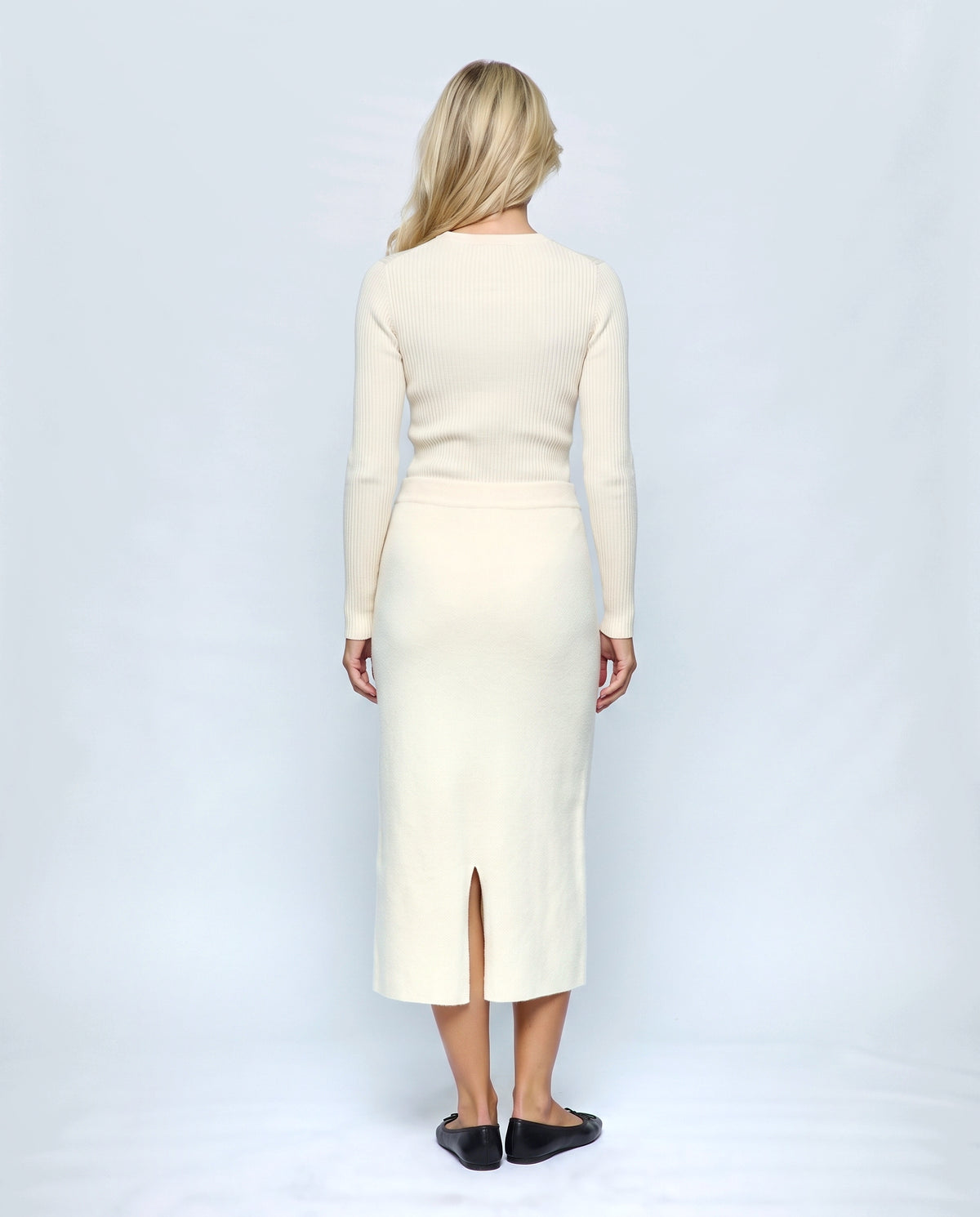 The Column Knit Skirt in Cream, back view on a non-pregnant model