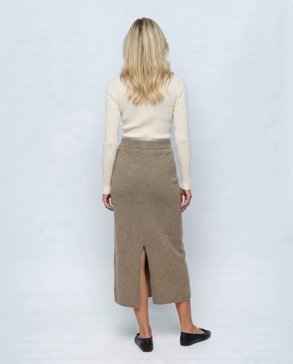 The Column Knit Skirt in Taupe, back view on a non-pregnant model