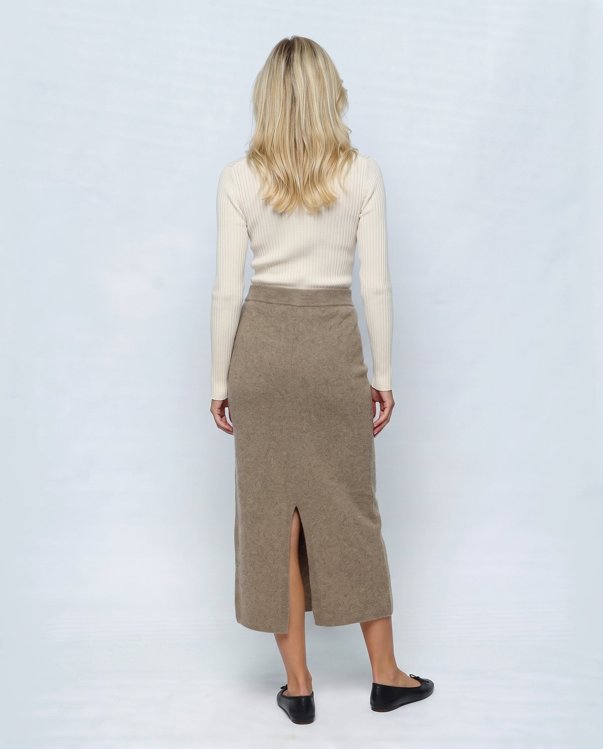 The Column Knit Skirt in Taupe, back view on a non-pregnant model