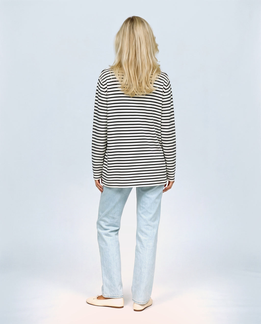 The Relaxed Maternity Stripe Top in Black stripe, back view on a non-pregnant model