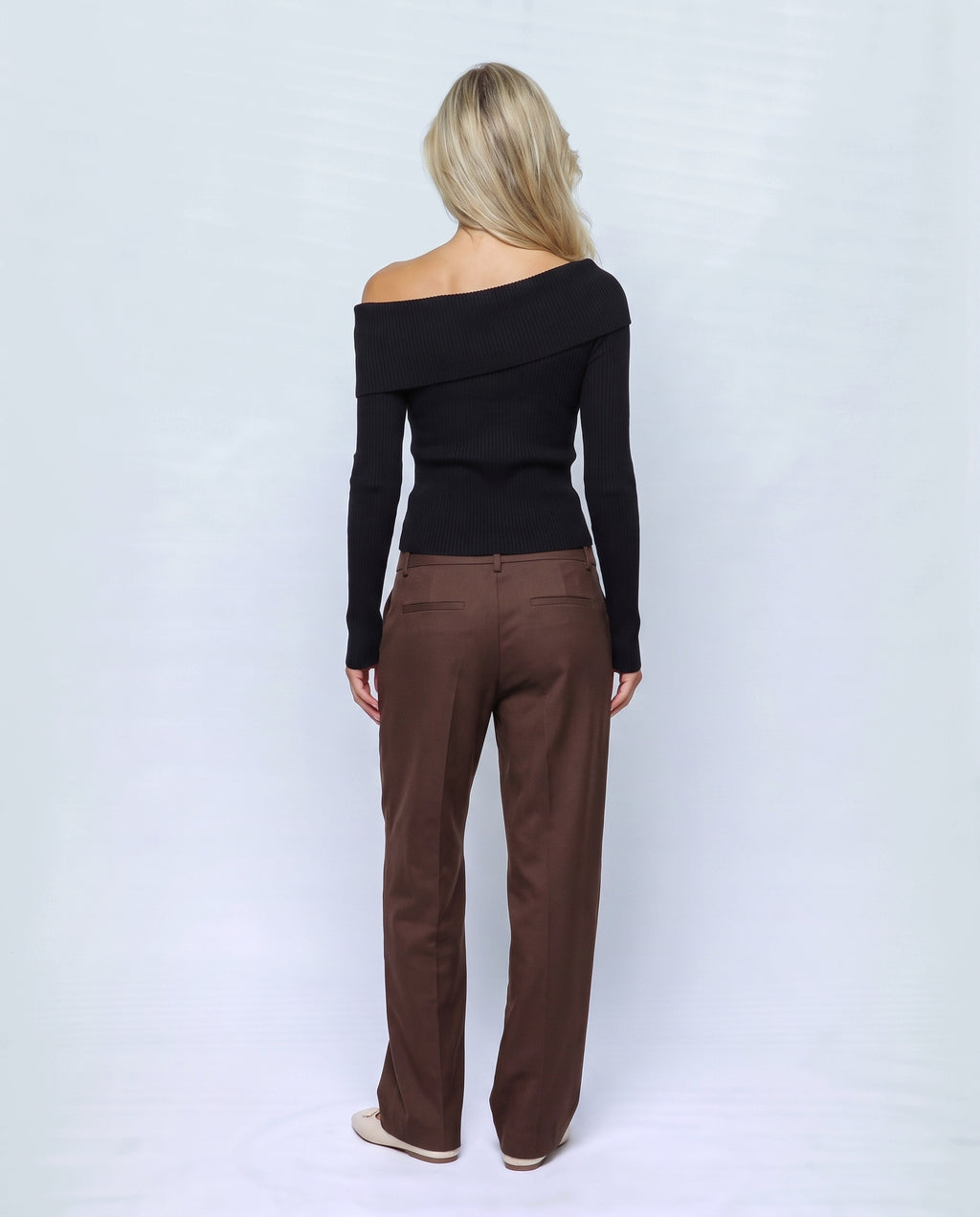 The Bardot Ribbed Top in Black, back view on a non-pregnant model