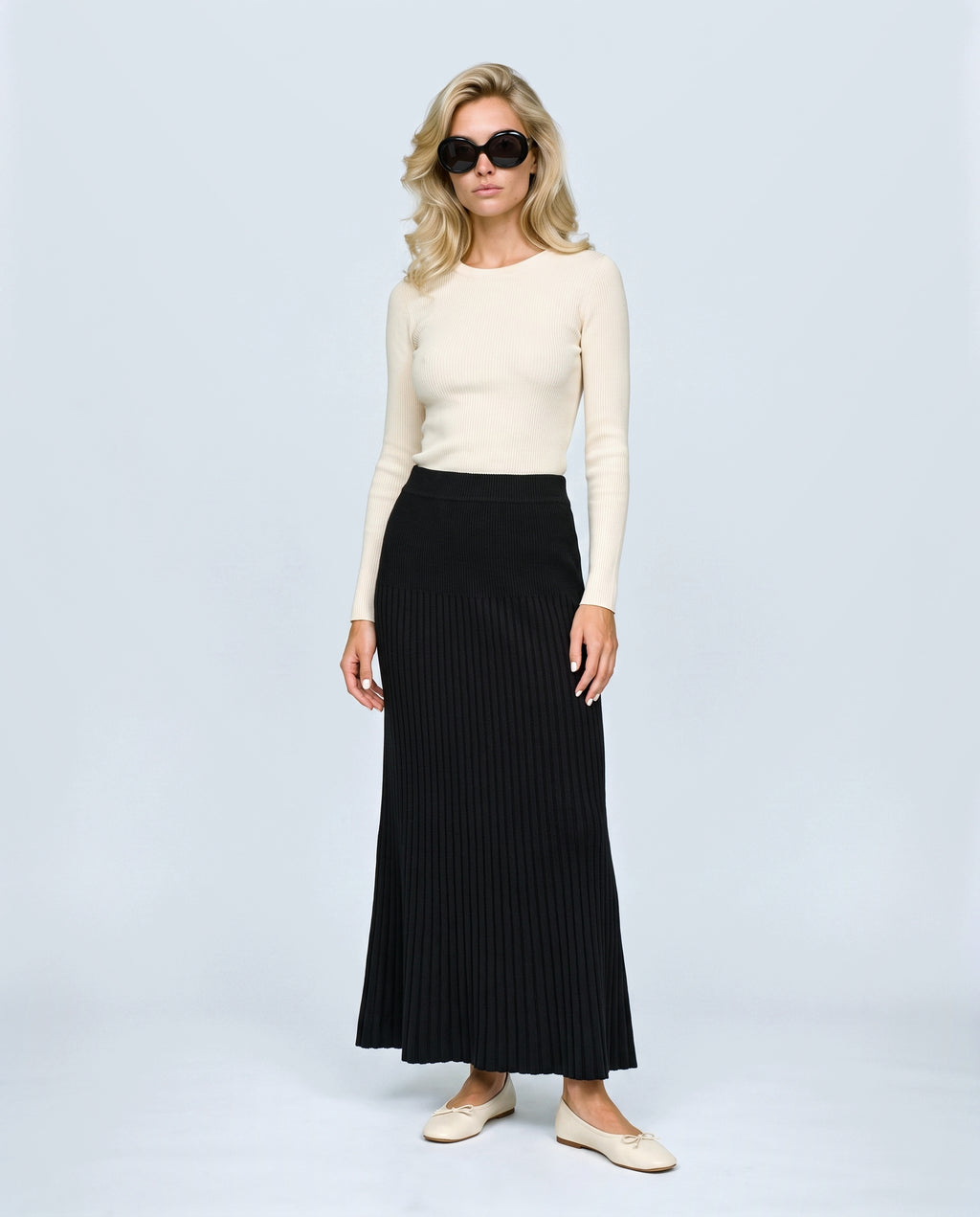 Ines Pleated Maternity Knit Skirt in Black, front view on a non-pregnant model