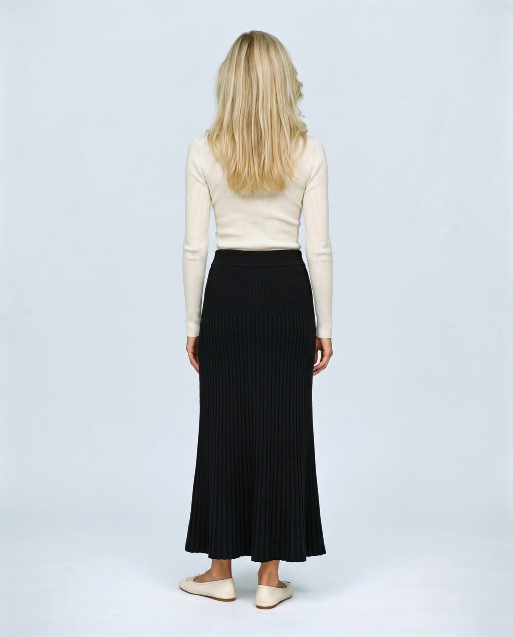 Ines Pleated Maternity Knit Skirt in Black, back view on a non-pregnant model