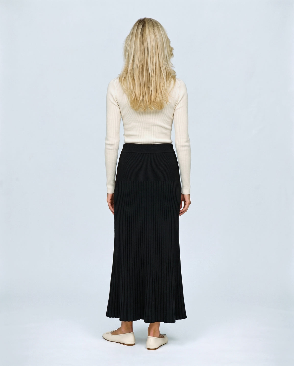 Ines Pleated Maternity Knit Skirt in Black, back view on a non-pregnant model