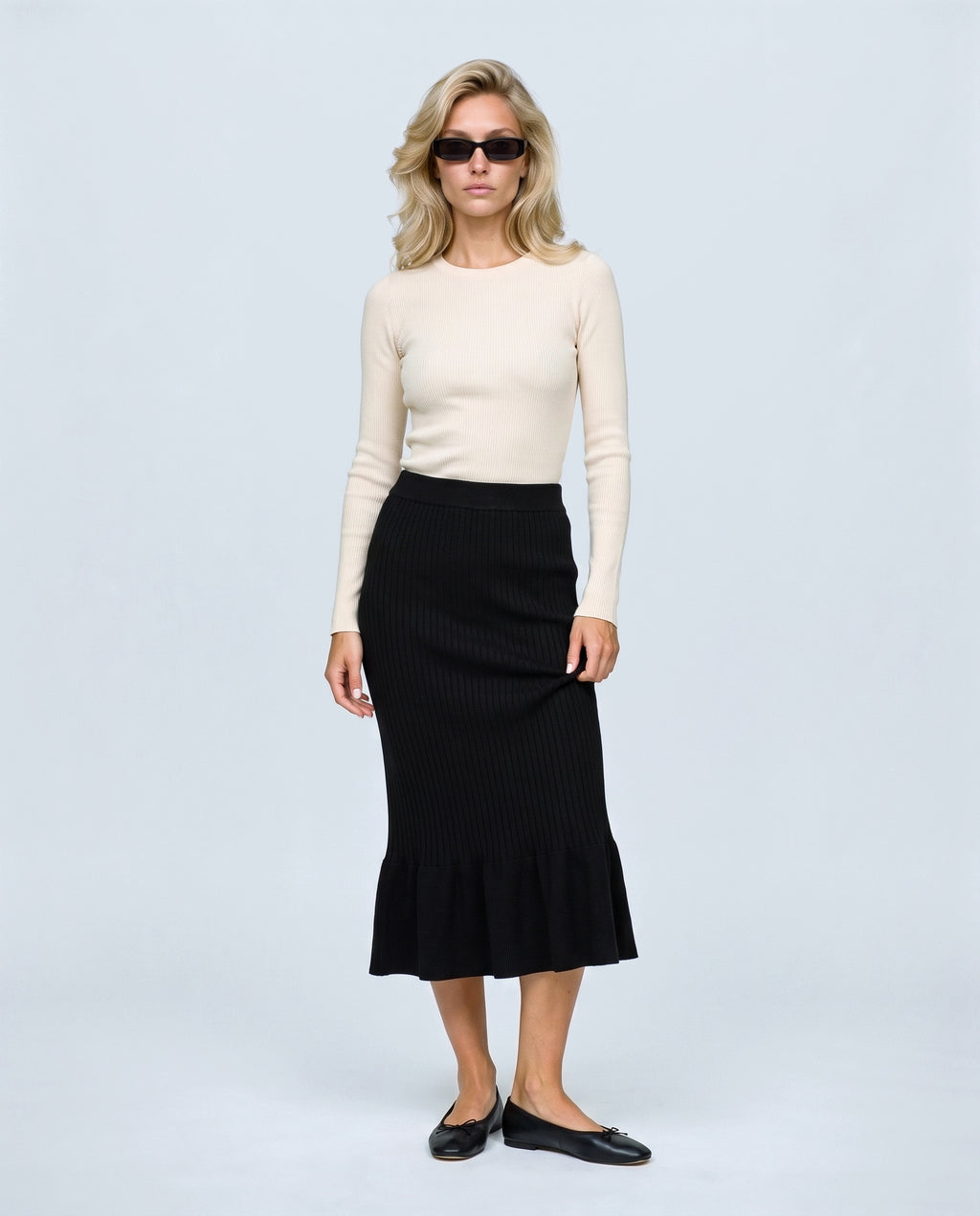 The Maternity Fluted Knit Skirt in Black, front view on a non-pregnant model