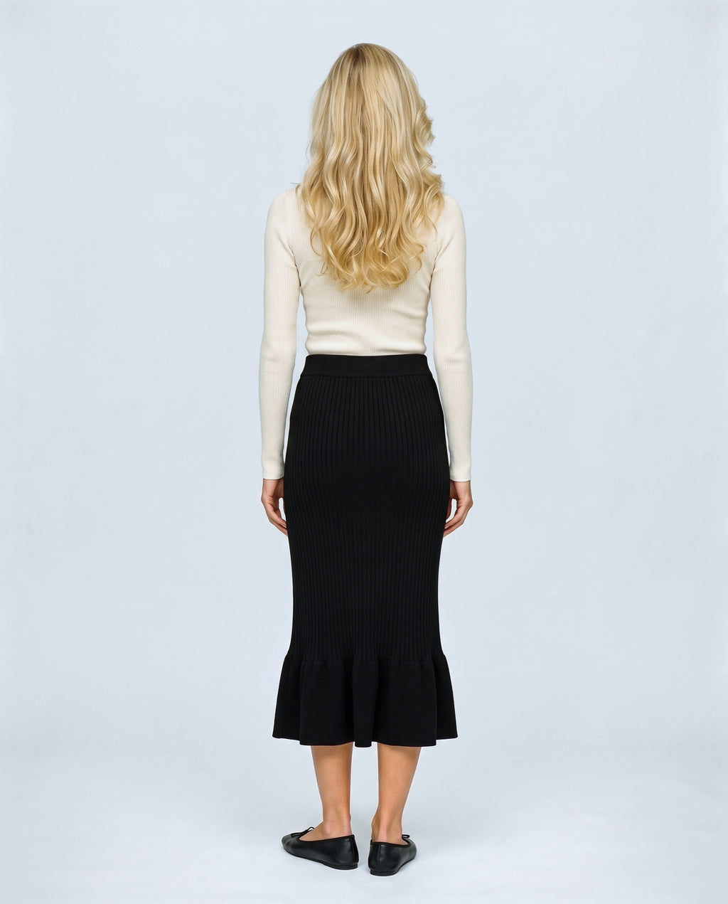The Maternity Fluted Knit Skirt in Black, back view on a non-pregnant model