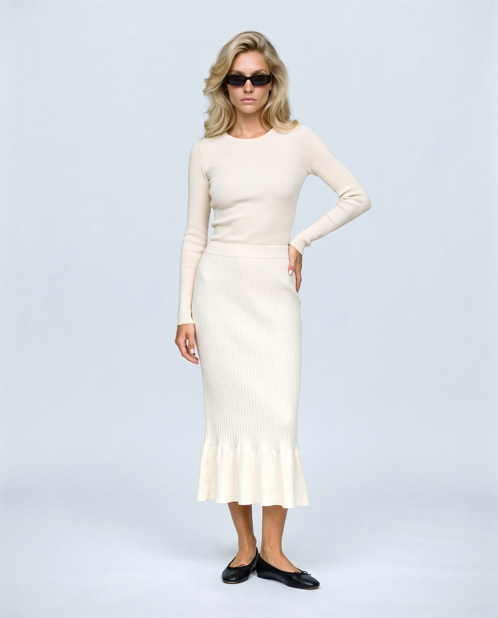 The Maternity Fluted Knit Skirt in Off-white, front view on a non-pregnant model