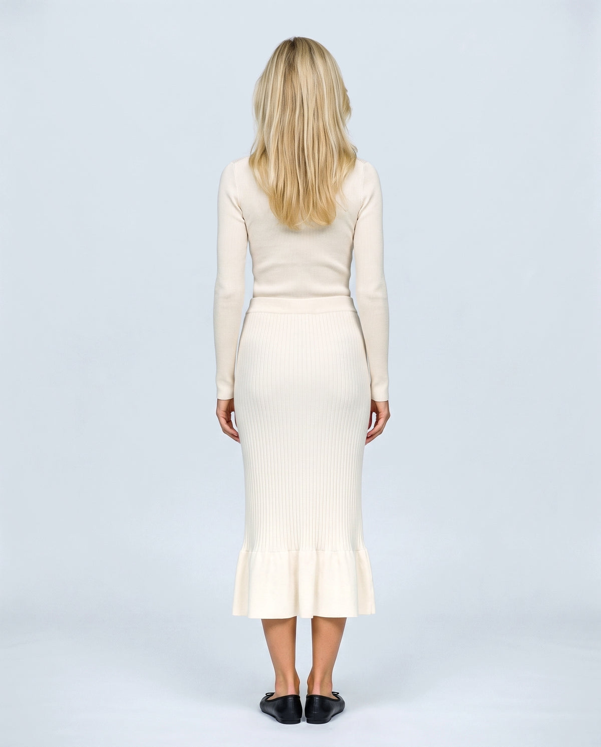 The Maternity Fluted Knit Skirt in Off-white, back view on a non-pregnant model