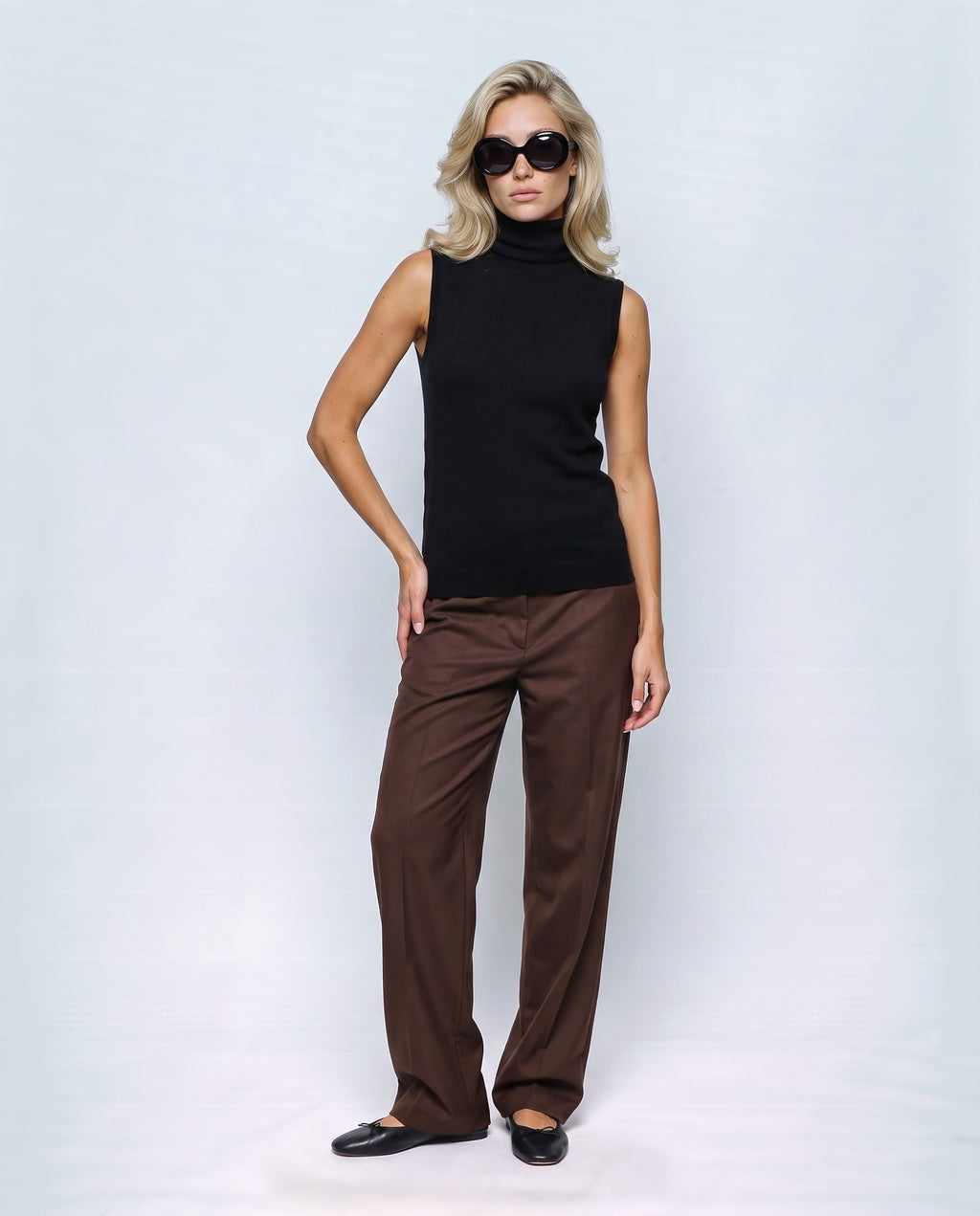 The Sleeveless Roll-Neck in Black, front view on a non-pregnant model