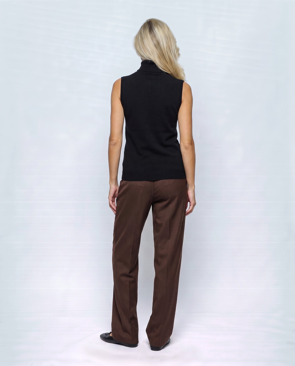 The Sleeveless Roll-Neck in Black, back view on a non-pregnant model