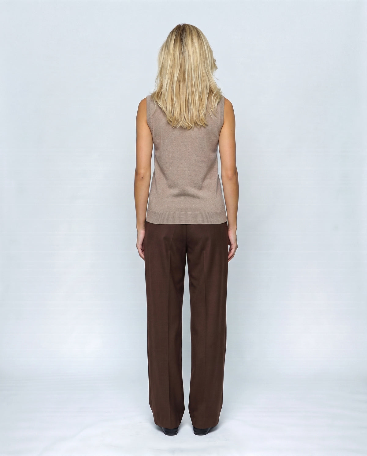 The Sleeveless Roll-Neck in Camel taupe, back view on a non-pregnant model