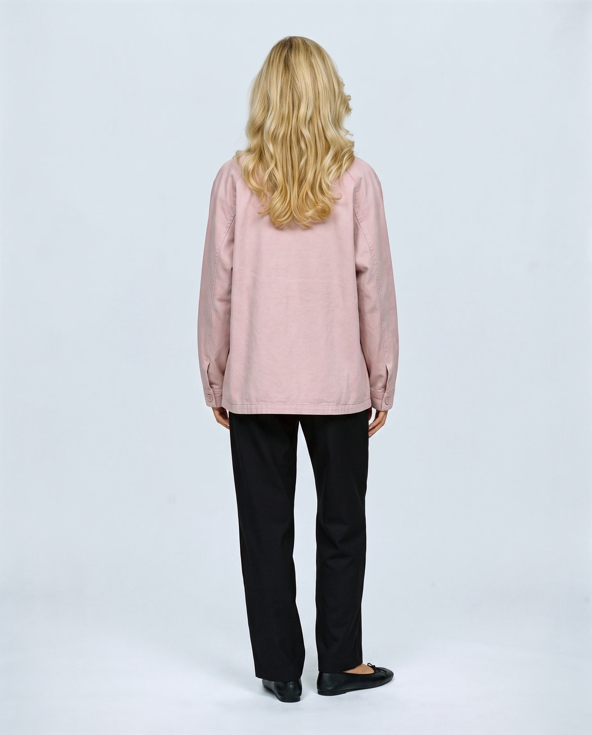 The Relaxed Utility Jacket in Light pink, back view on a non-pregnant model