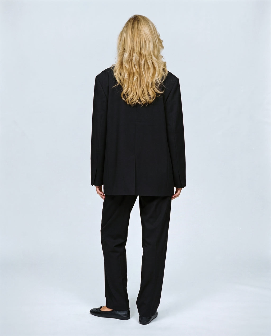 The Relaxed Double-Breasted Blazer in Black, back view on a non-pregnant model
