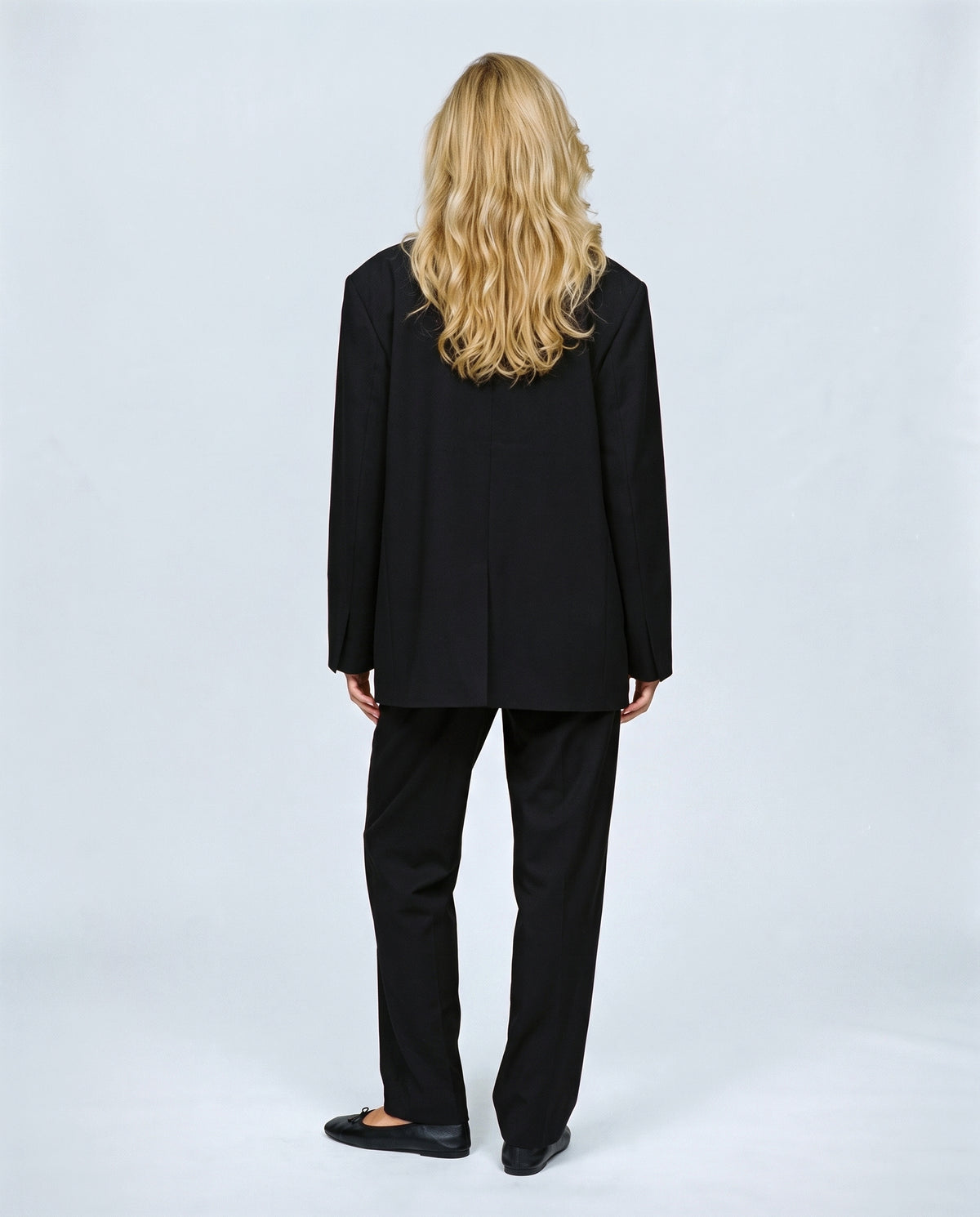 The Relaxed Double-Breasted Blazer in Black, back view on a non-pregnant model