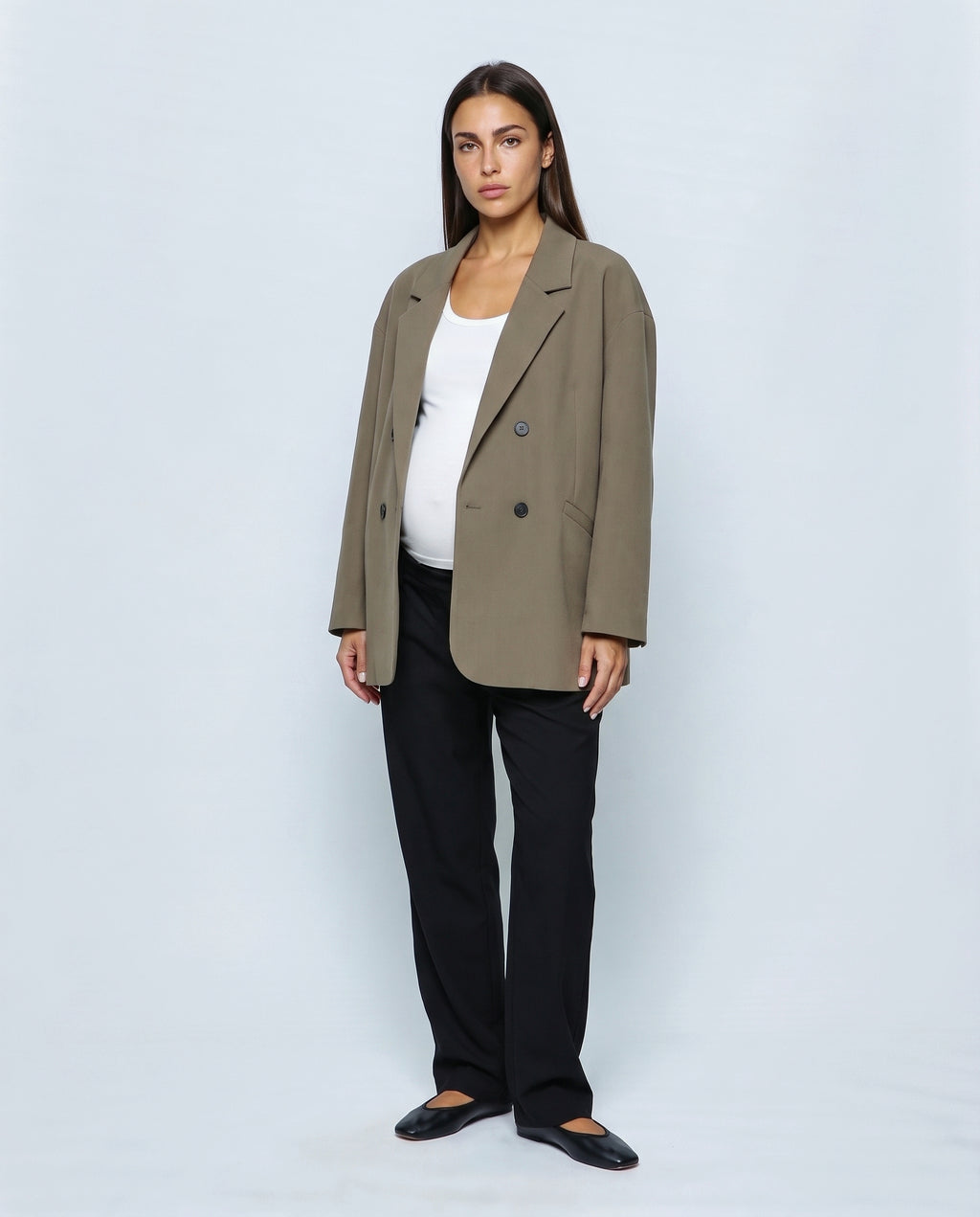 The Relaxed Double-Breasted Blazer in Khaki olive, closed over the bump
