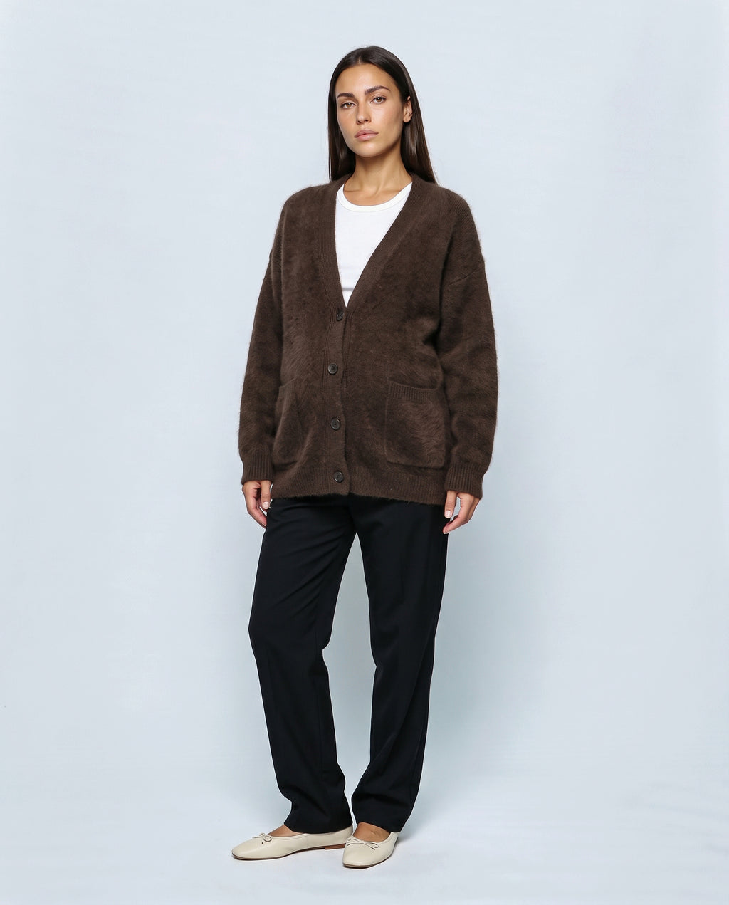 The Deep-V Cardigan in Brown, closed over the bump