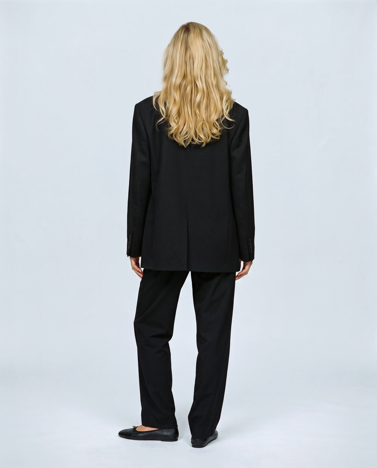 The Relaxed Pinstripe Blazer in Black, back view on a non-pregnant model