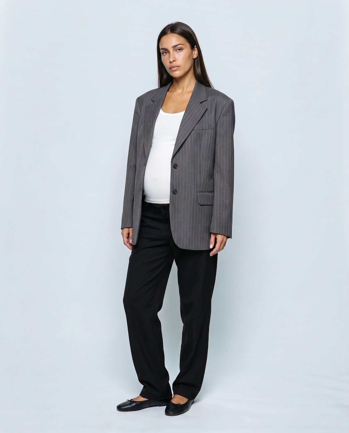 The Relaxed Pinstripe Blazer in Grey pinstripe, closed over the bump