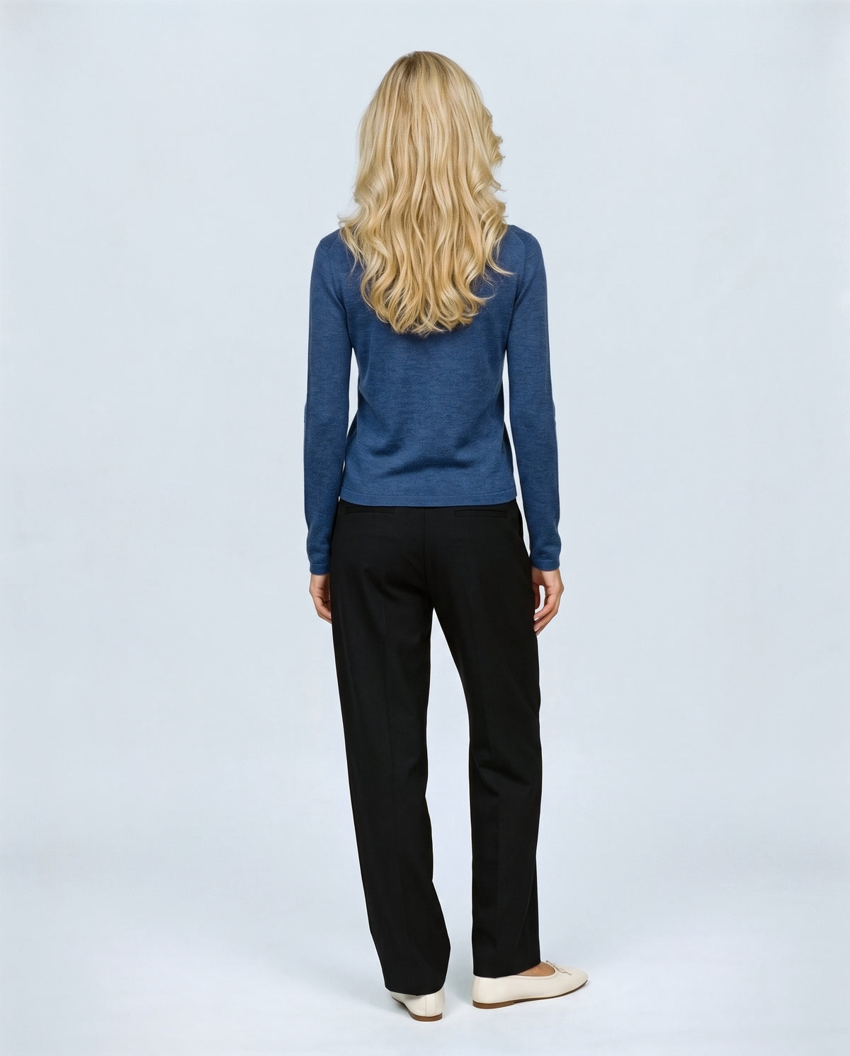 The Refined Crewneck Knit in Ink blue, back view on a non-pregnant model
