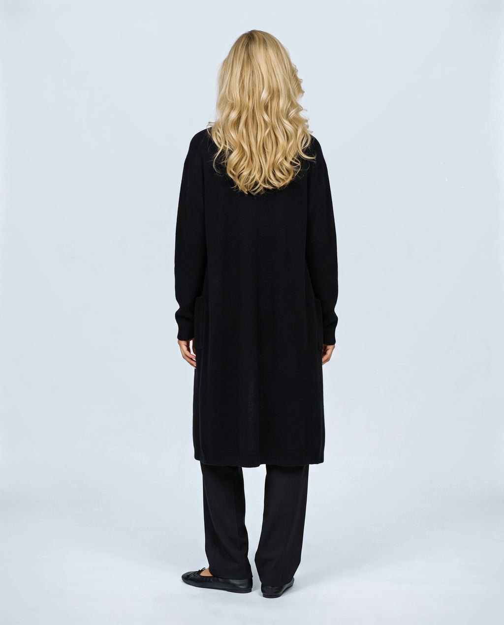 The Open-Front Longline Cardigan in Black, back view on a non-pregnant model