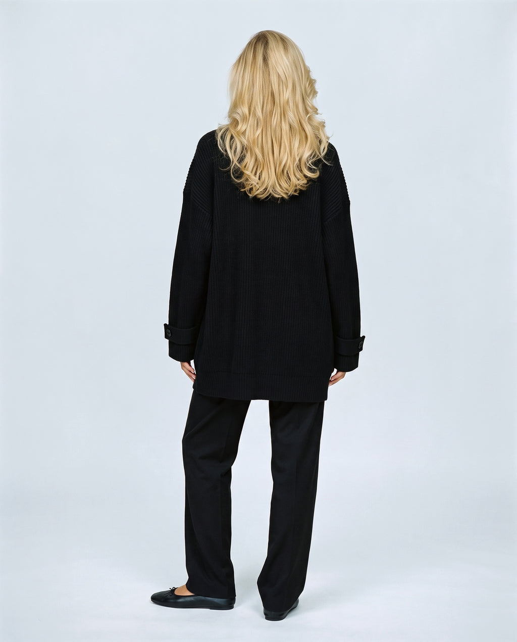 Simone Longline Knit Cardigan in Black, back view on a non-pregnant model