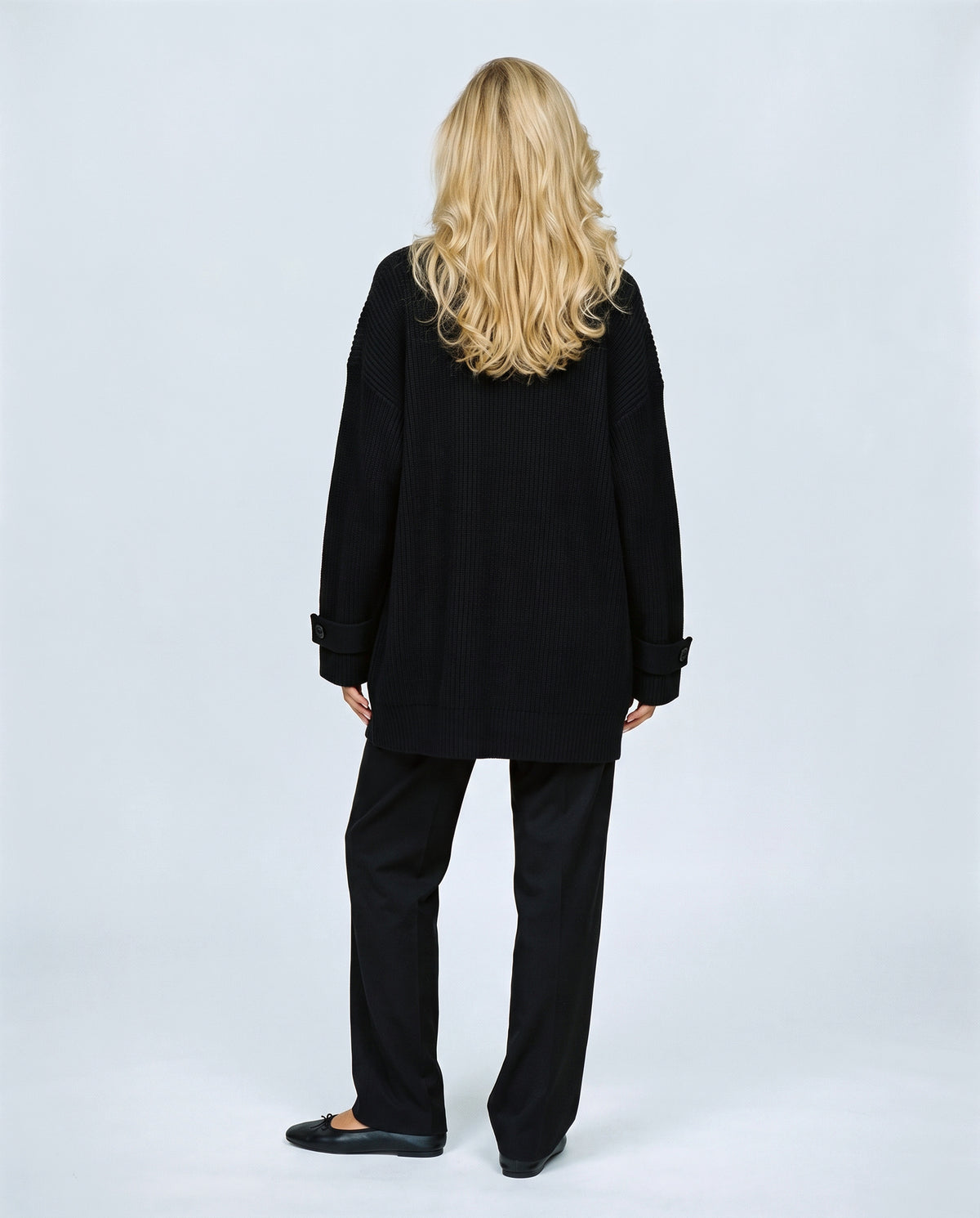 Simone Longline Knit Cardigan in Black, back view on a non-pregnant model