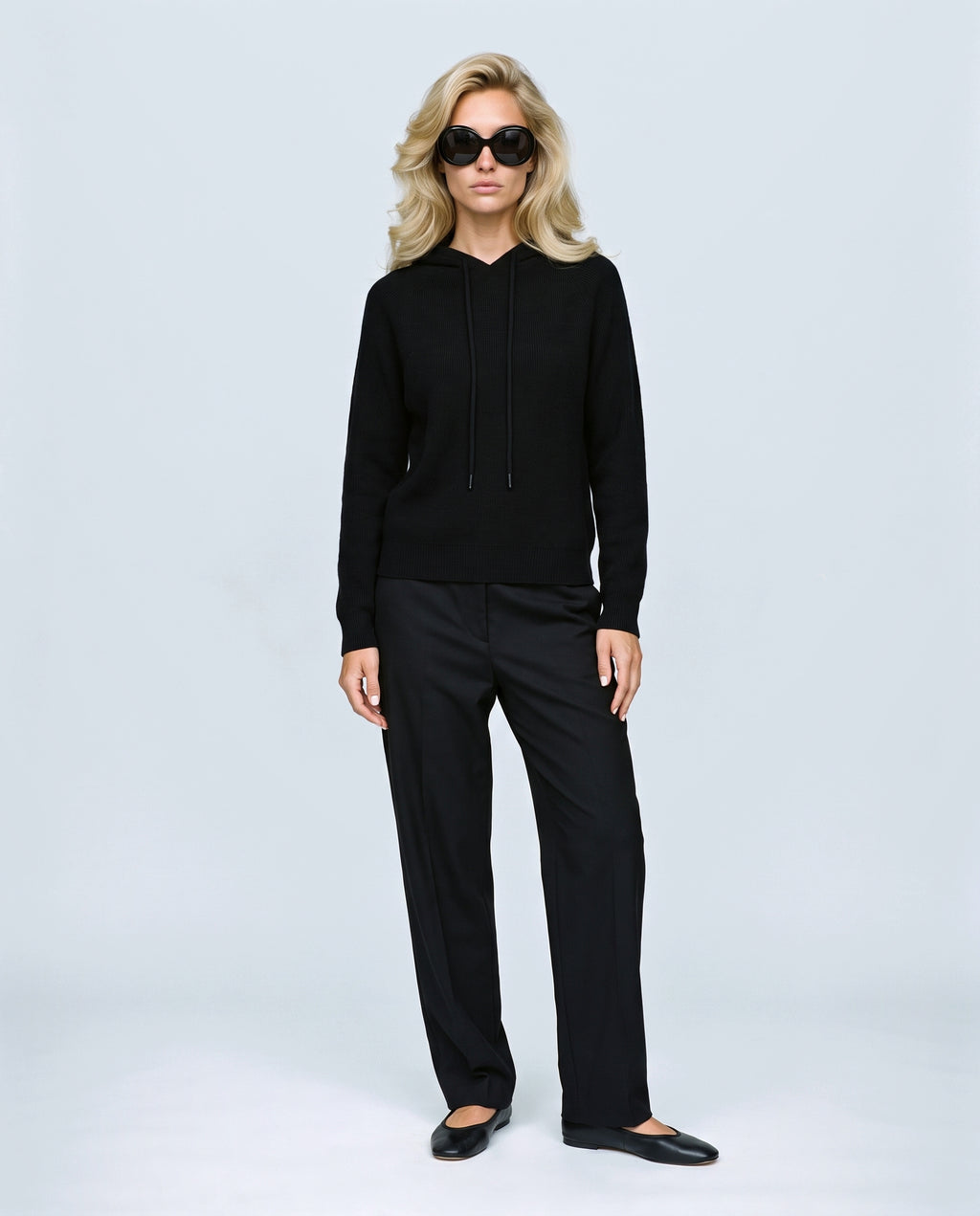The Relaxed Knit Hoodie in Black, front view on a non-pregnant model