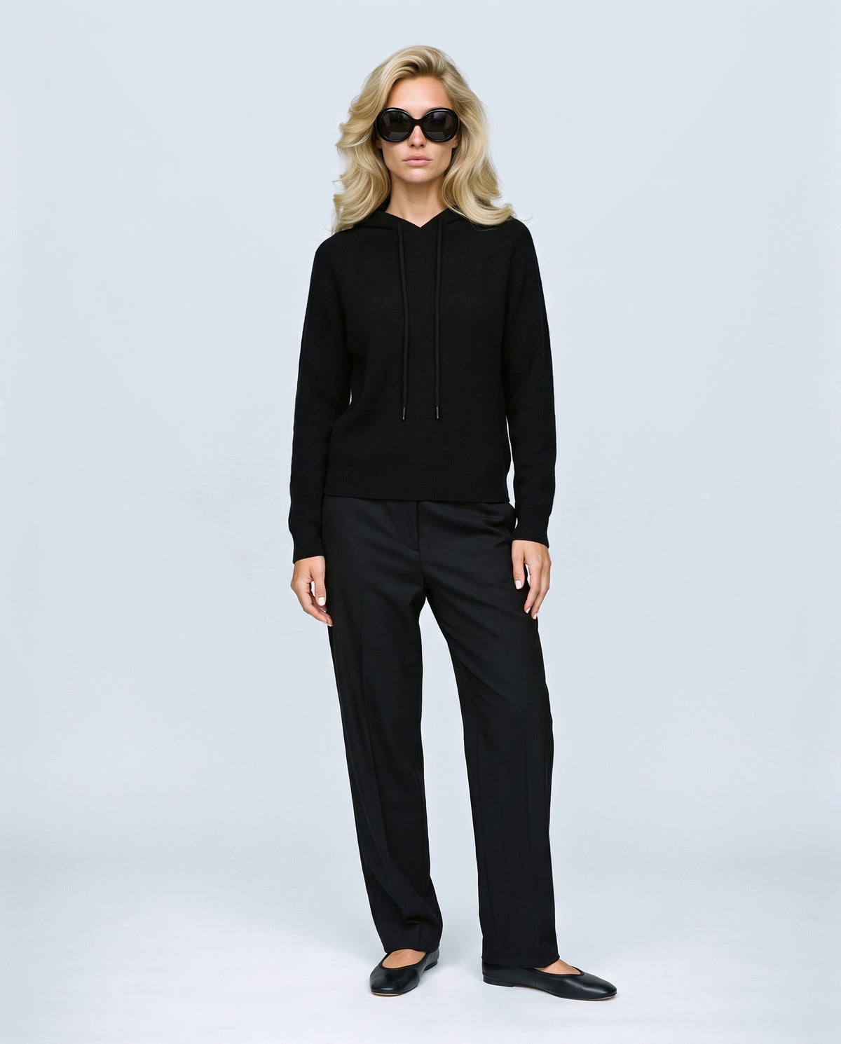 The Relaxed Knit Hoodie in Black, front view on a non-pregnant model
