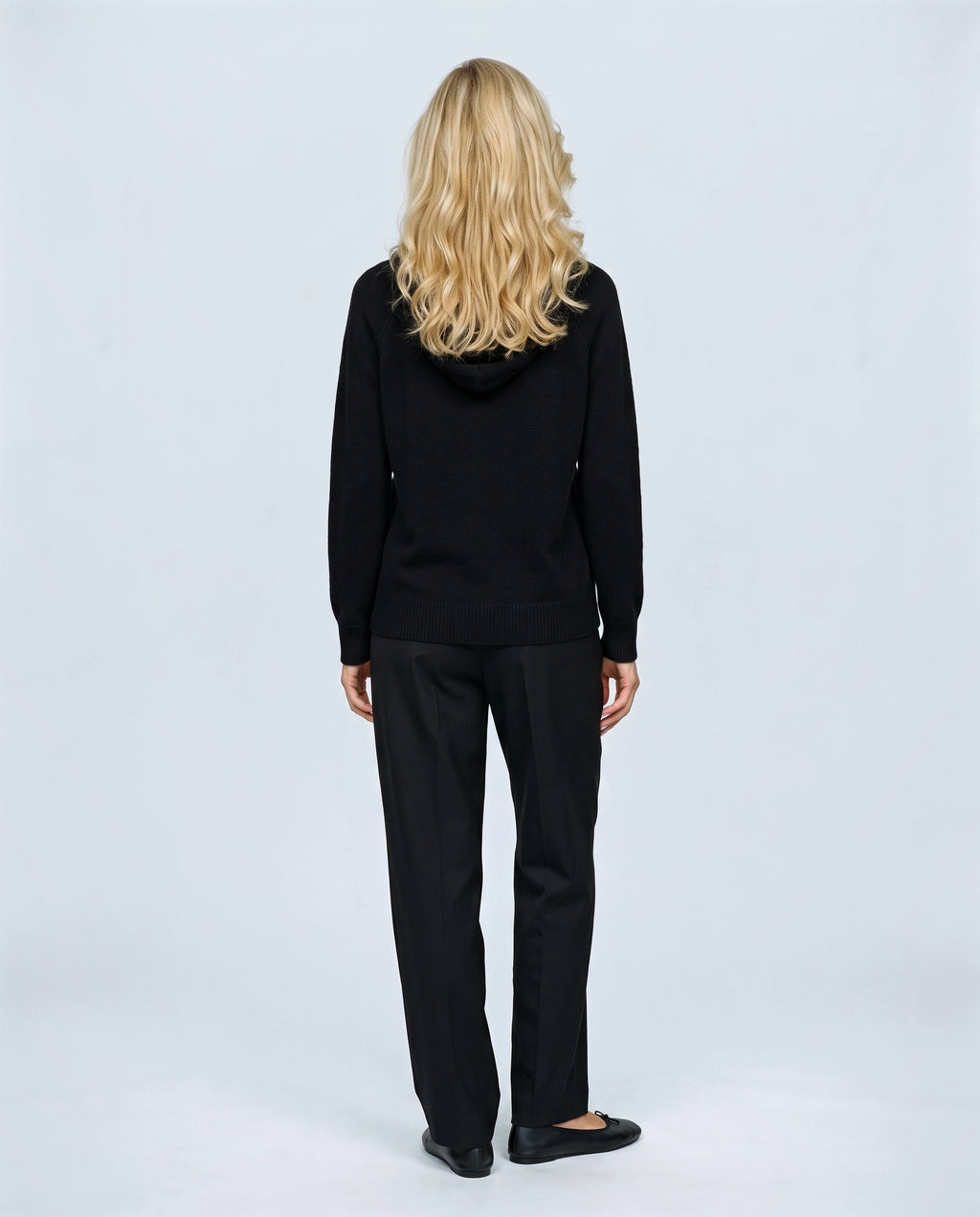 The Relaxed Knit Hoodie in Black, back view on a non-pregnant model
